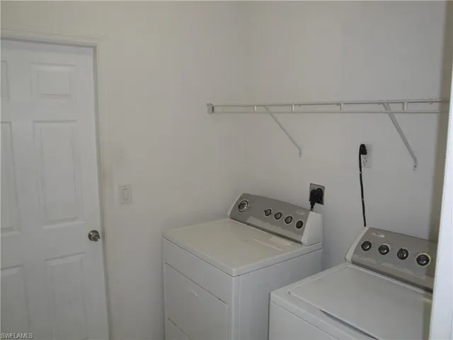 Inside laundry with shelving for detergent etc.