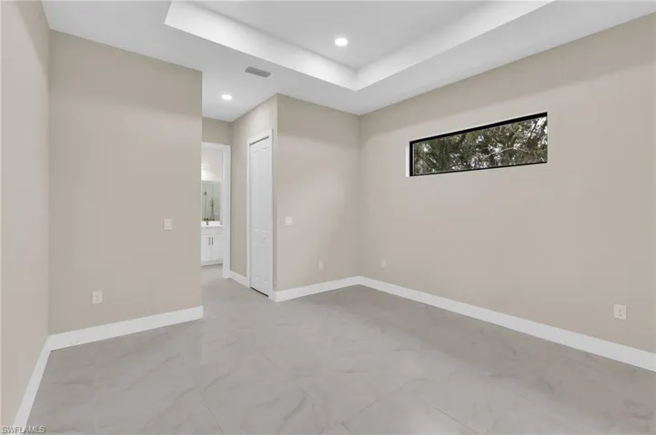 Spare room with a raised ceiling and recessed lighting