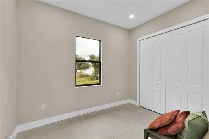 Living area with baseboards and recessed lighting