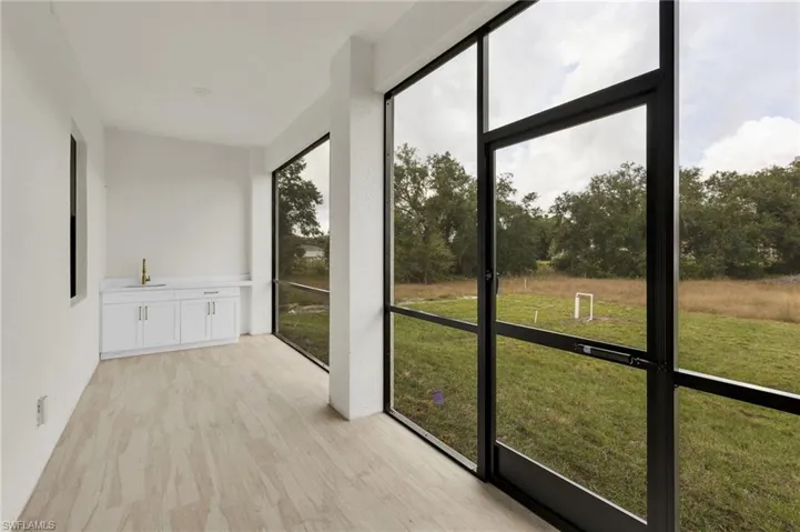 Unfurnished sunroom with a sink