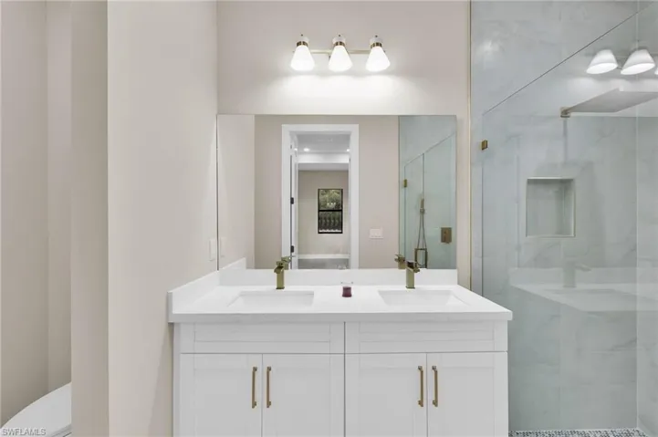 Bathroom with double vanity and a shower stall