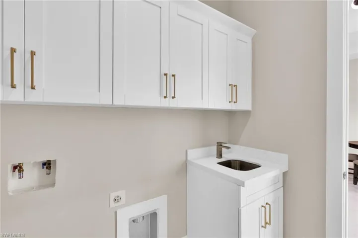 Washroom featuring cabinet space and hookup for a washing machine