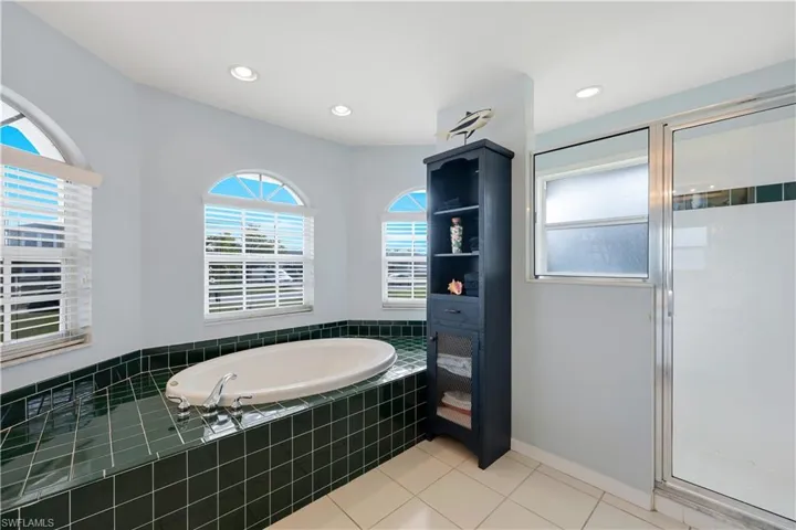 Bathroom featuring tile patterned floors and independent shower and bath