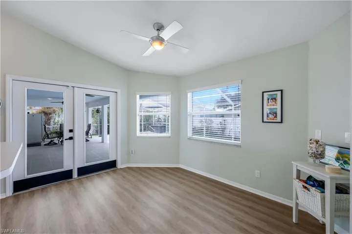 Unfurnished room with french doors, ceiling fan, vaulted ceiling, and hardwood / wood-style floors