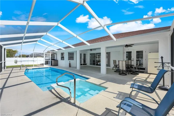 View of swimming pool featuring a patio, french doors, ceiling fan, and glass enclosure