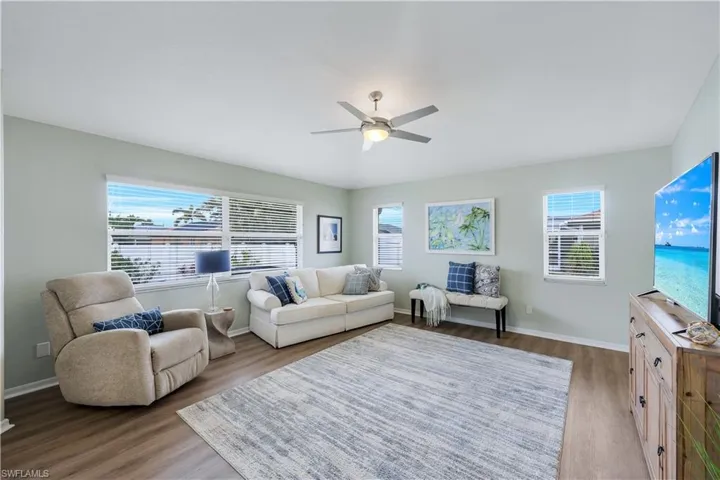 Living room featuring hardwood / wood-style flooring, plenty of natural light, and ceiling fan