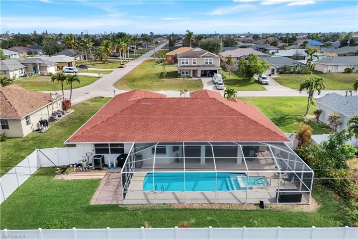 View of swimming pool with a lawn, a patio, and glass enclosure