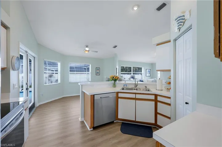 Kitchen featuring sink, light hardwood / wood-style flooring, kitchen peninsula, and appliances with stainless steel finishes