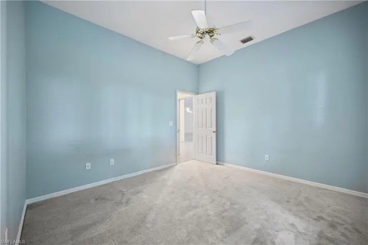 Unfurnished room featuring carpet flooring and ceiling fan