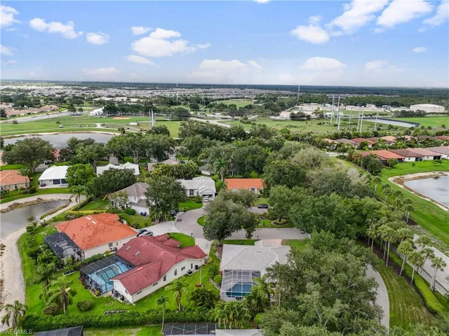 Aerial perspective of suburban area featuring a nearby body of water