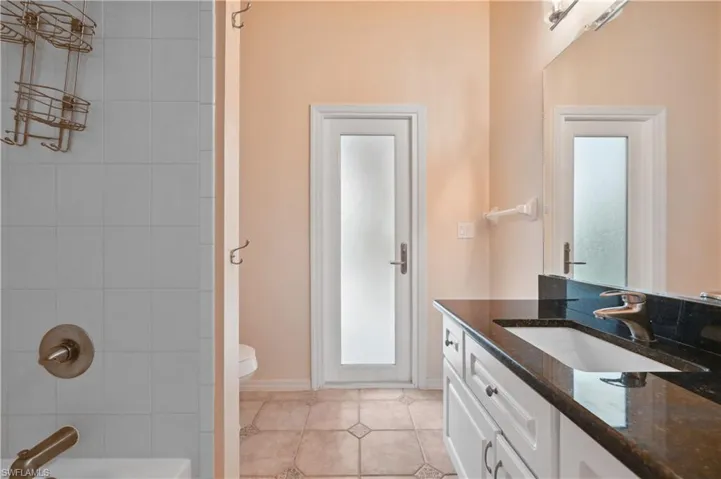 Full bathroom with vanity,  shower combination, and light tile patterned floors