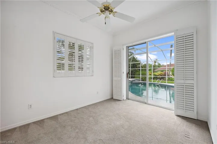 With Plantation Shutters on window and Sliding Doors to Pool Area