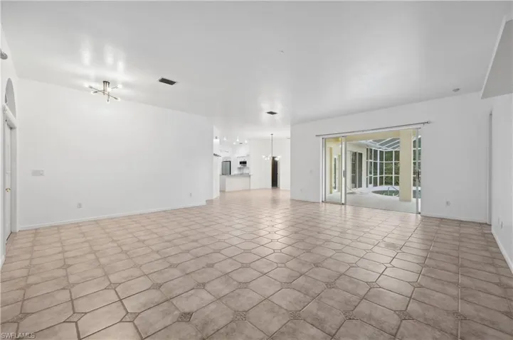 Unfurnished living room with baseboards