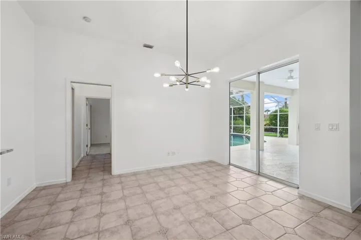 Unfurnished dining area with a chandelier, a sunroom, and ceiling fan