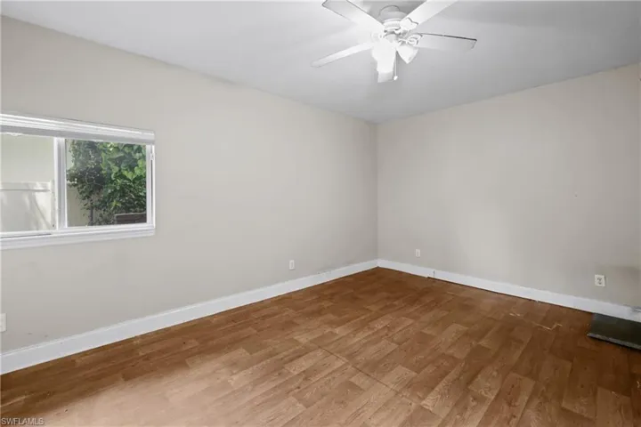 Empty room featuring wood finished floors and a ceiling fan