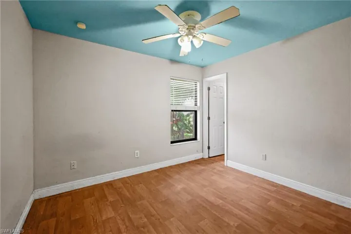 Spare room featuring wood finished floors and a ceiling fan