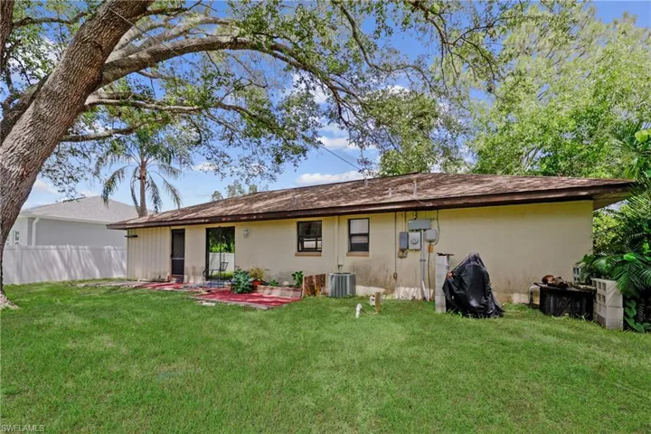 Back of house featuring stucco siding