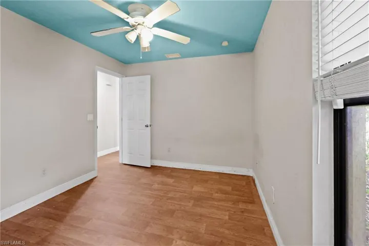 Empty room with ceiling fan and wood finished floors