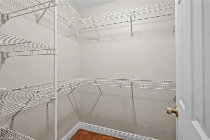 Spacious closet featuring wood finished floors