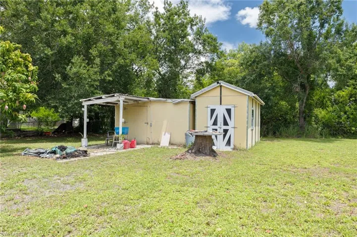 View of shed with a pergola and view of scattered trees