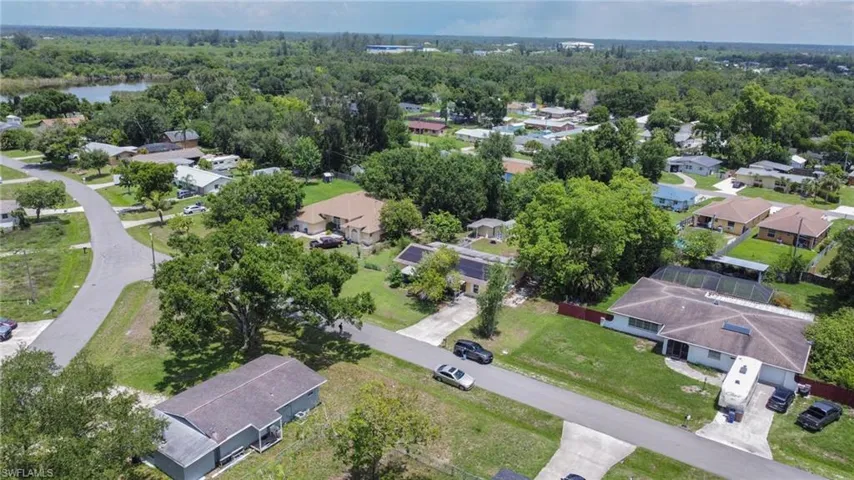 Aerial view of property's location with nearby suburban area and a nearby body of water