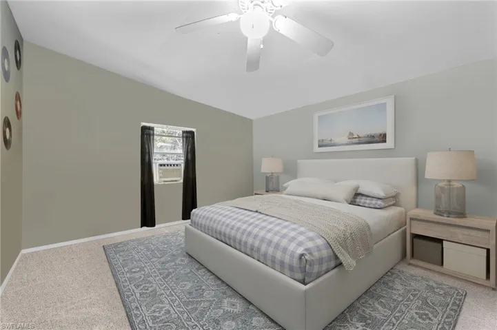 Bedroom with carpet, vaulted ceiling, cooling unit, and ceiling fan