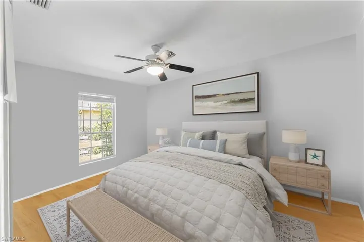 Bedroom with light wood-style floors and a ceiling fan