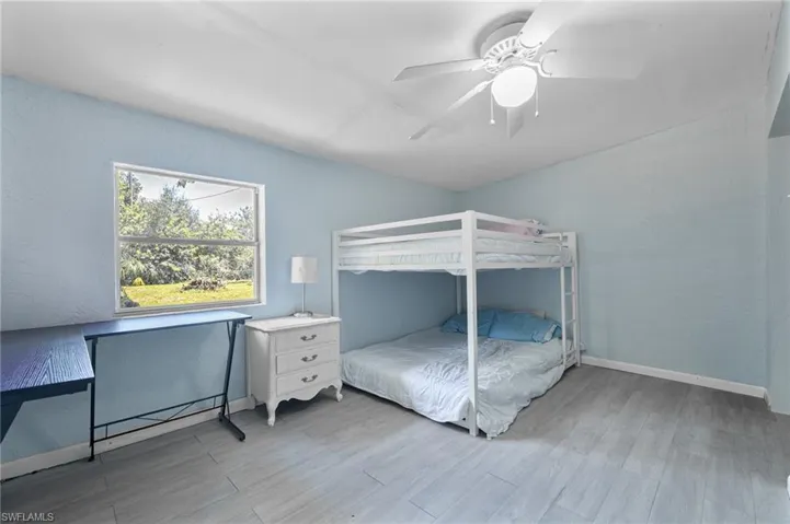 Bedroom with wood finished floors and a ceiling fan