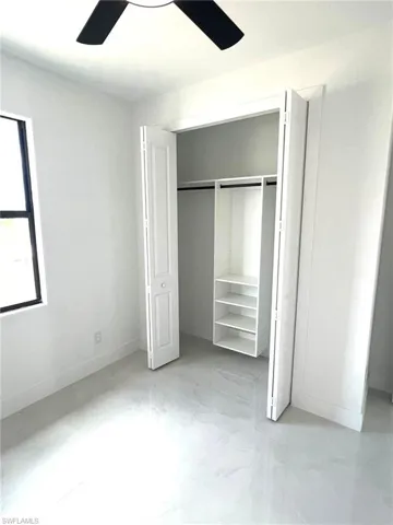 Unfurnished bedroom with tile floors and ceiling fan