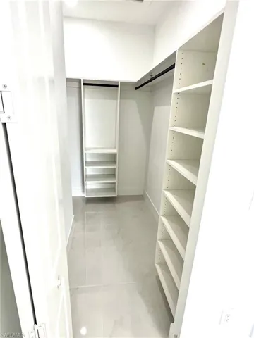 Spacious closet featuring tile flooring