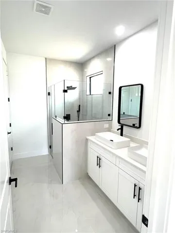 Bathroom featuring dual vanity and tile flooring