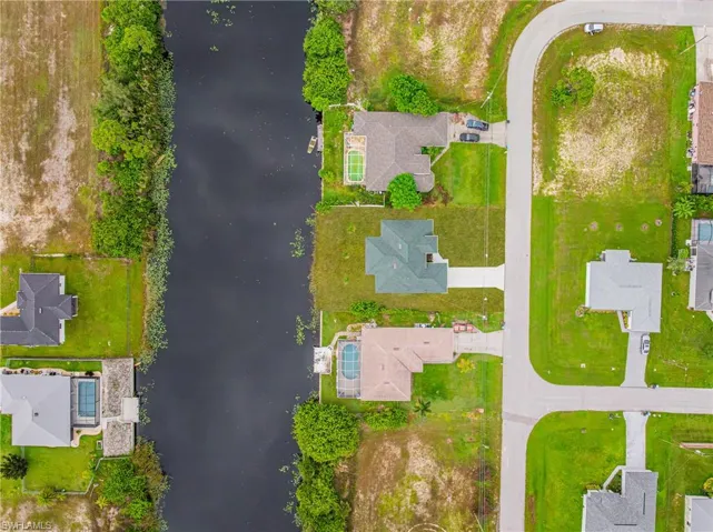 Aerial perspective of suburban area featuring a large body of water