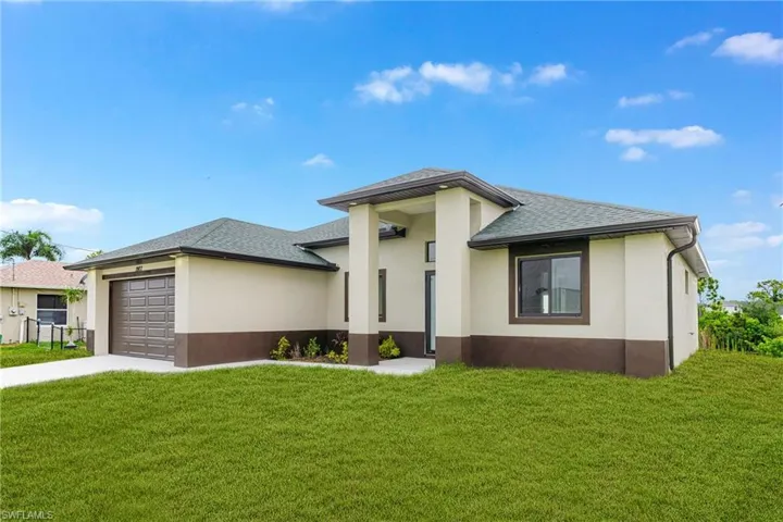 Prairie-style home featuring roof with shingles, stucco siding, a garage, driveway, and a front yard