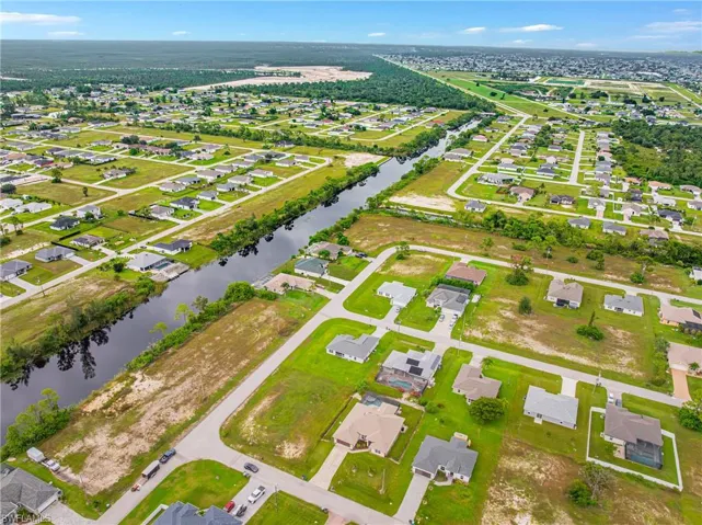 Aerial view of property's location featuring nearby suburban area and a large body of water