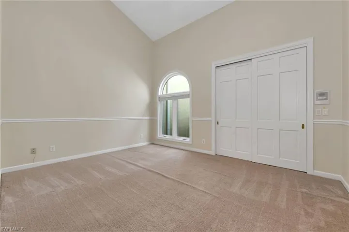 Guest bedroom high vaulted ceiling, a closet. Carpet has been replaced