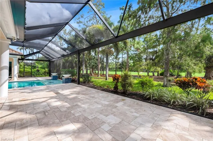 View of swimming pool featuring picture frame screen enclosure and a patio area