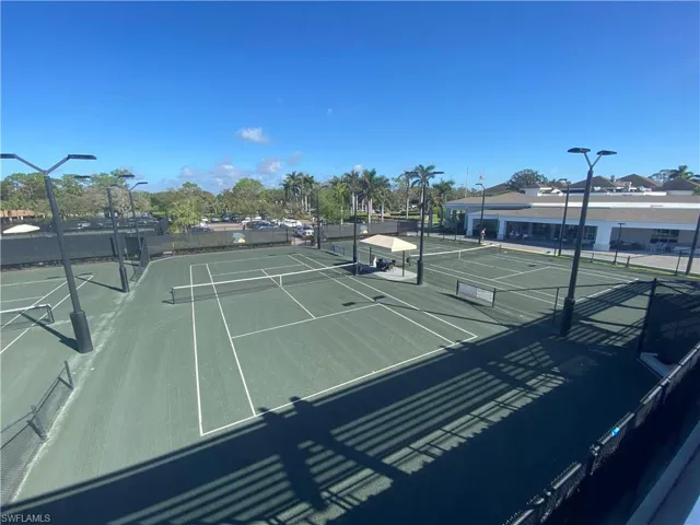 View of 2 of the 10 Har-Tru tennis courts with tennis pro shop