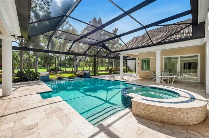 View of swimming pool featuring a lanai, an in ground hot tub, and a patio