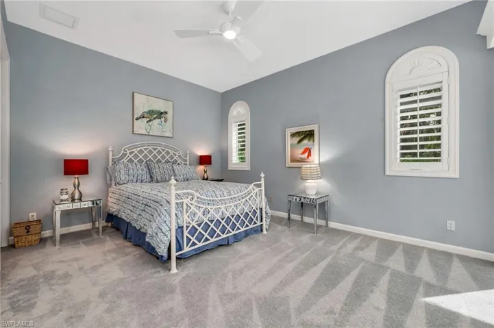 Guest suite with multiple windows, ceiling fan, and carpet