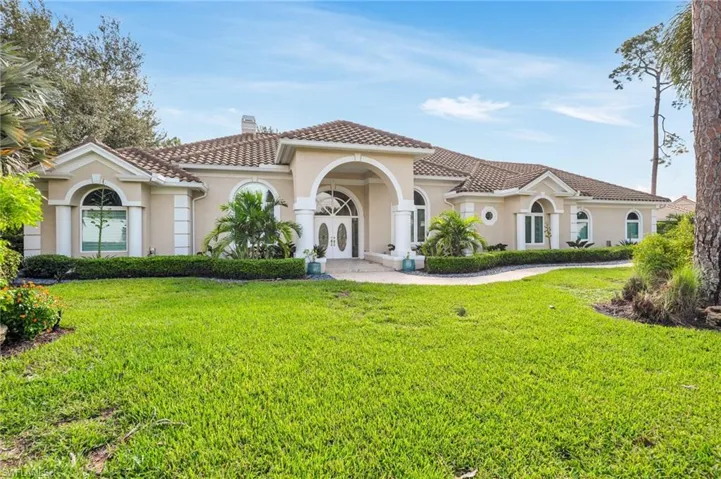 Mediterranean / spanish home with a front yard