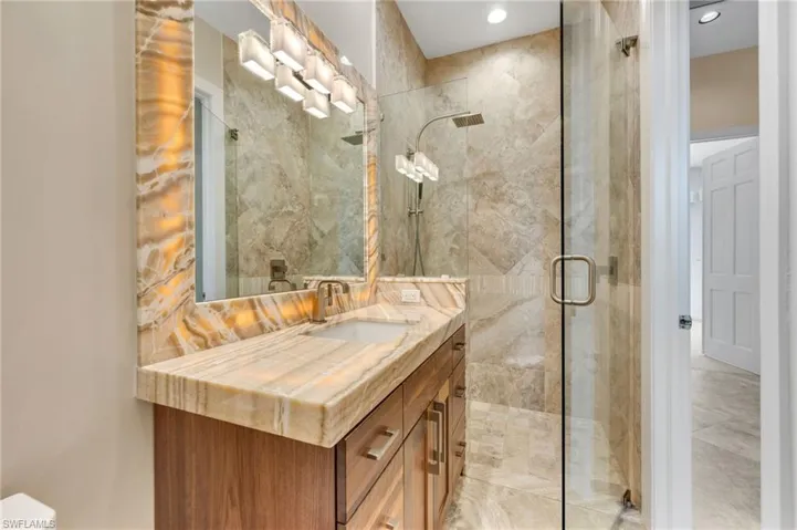 Bathroom featuring walk in shower and vanity
