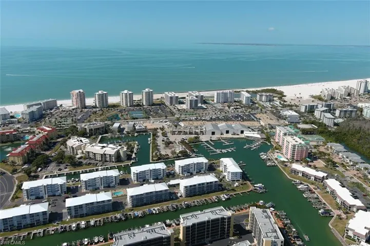 9  WHITE ROOF BLDGS this bldg 3rd from left closest to the beach