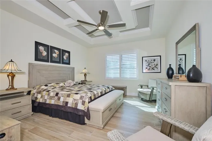 Primary Bedroom with Plantation Shutters with Fabulous Coffered Ceiling and Fan