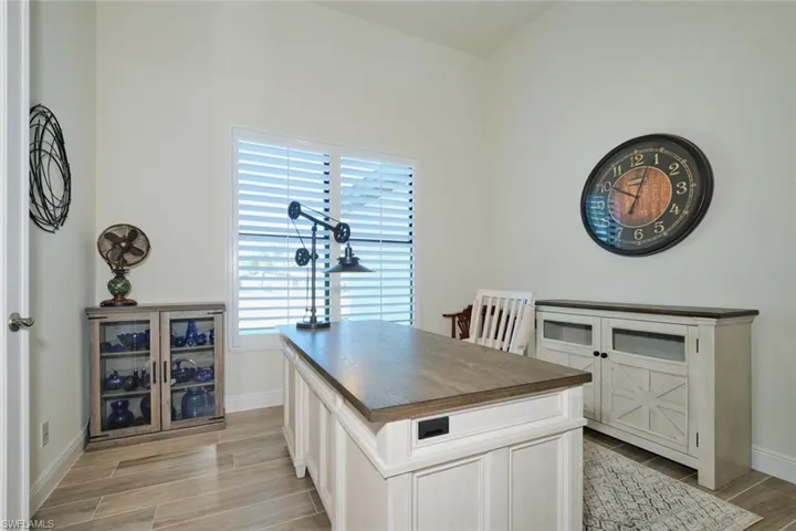 DEN is Light and bright with Plantation Shutters and Glass door to Foyer