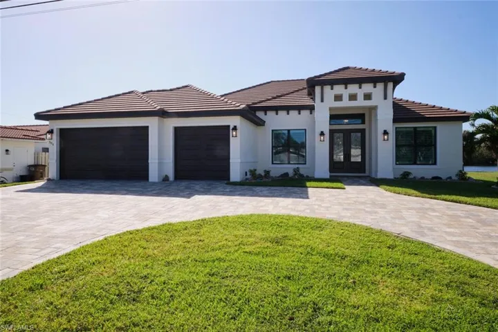 Triple car garage with circle Paver driveway and walkway