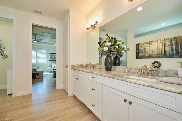 Primary Bathroom featuring Dual Sinks adjacent to Primary Bedroom