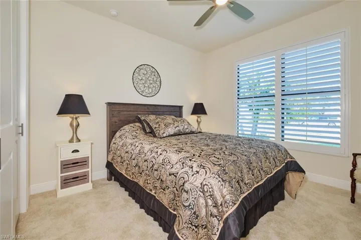 Guest Bedroom with Plantation Shutters and Neutral Carpet ceiling fan