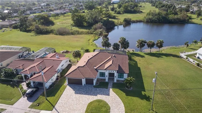 Aerial view featuring  home, circle drive and Pond