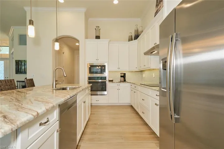 Stainless steel appliances and  sink and pendant lighting