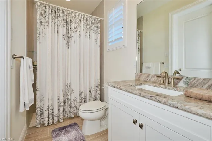 POOL Bathroom with Granite Counter,  -Plantation Shutter and  access to Lanai and Pool